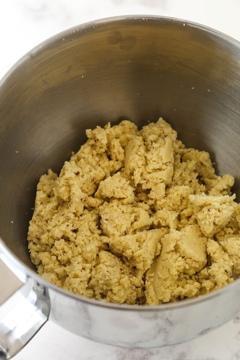 Almond crescent cookie dough in a mixing bowl.