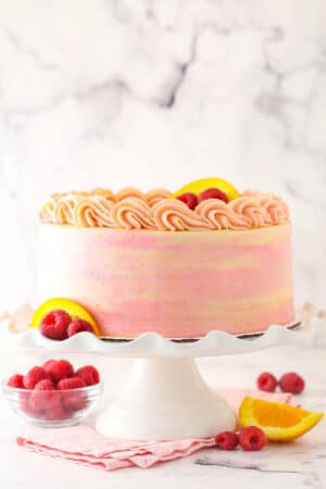 Tray of refreshing summer cakes featuring berry icebox cake, lemon summer cake, and strawberry summer cake with vibrant fruit toppings.