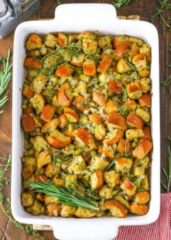 Overhead view of Classic Homemade Stuffing in a white serving platter on a wooden table