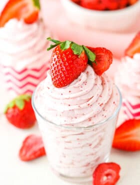 Homemade Strawberry Whipped Cream piped into a clear glass