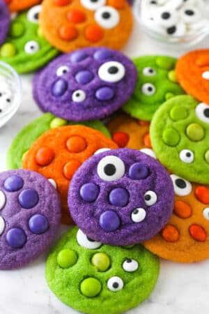 Close up of a pile of brightly colored Halloween Monster Cookies with eyeballs.