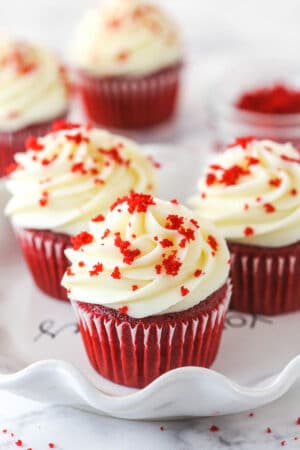 Red velvet cupcakes garnished with red velvet crumbles.