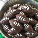 Overhead image of cookie dough footballs on a serving plate.