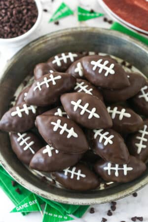 Overhead image of cookie dough footballs on a serving plate.