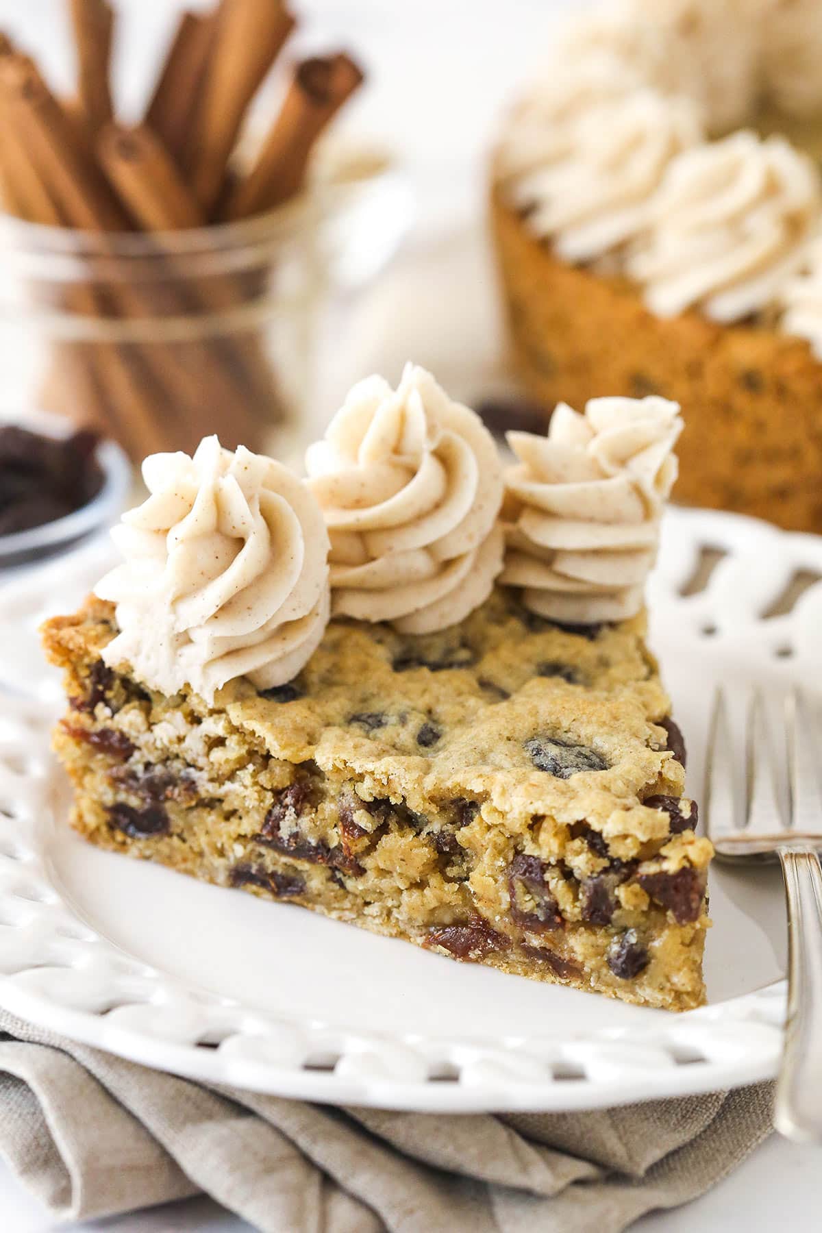 A slice of oatmeal raisin cookie cake on a plate.