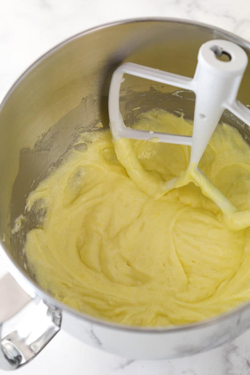 Mixing eggs into cupcake batter.