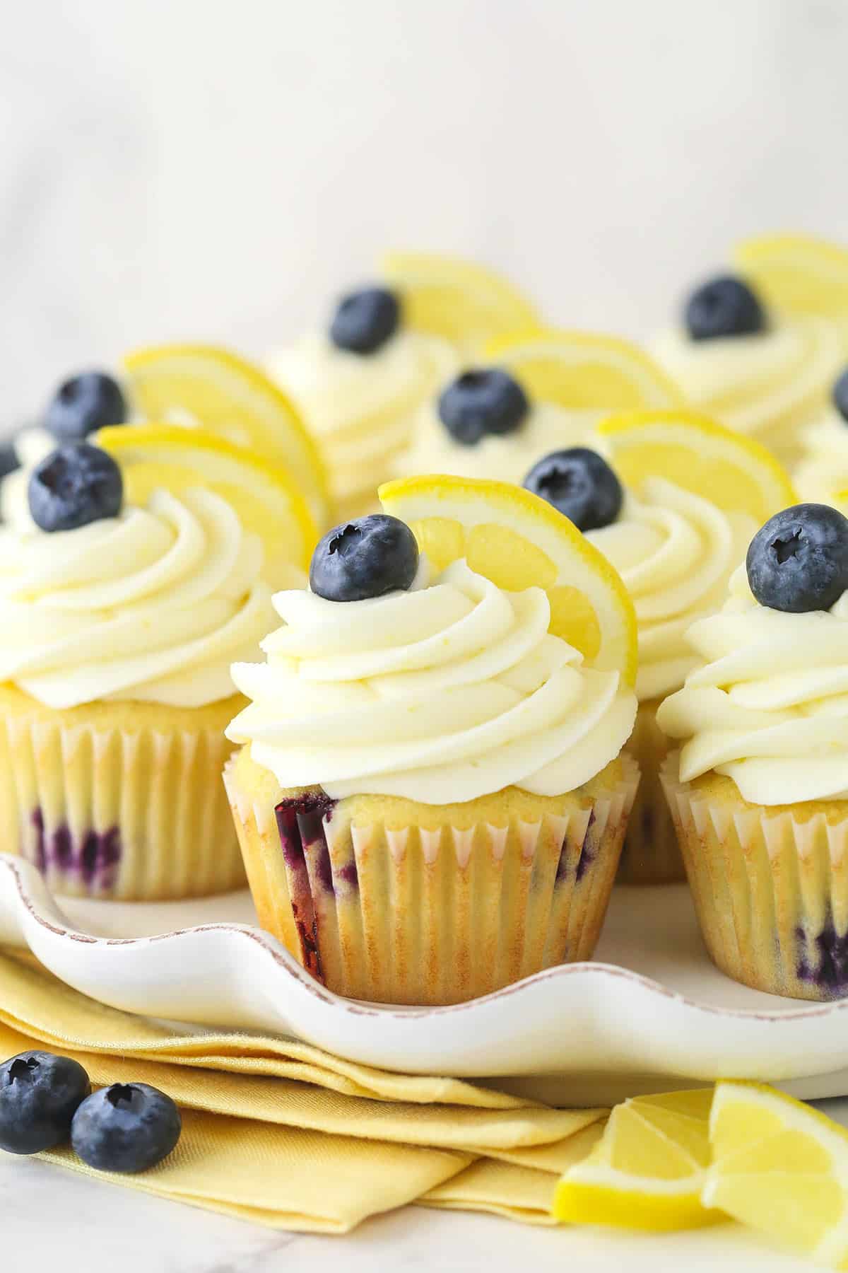 Lemon blueberry cupcakes on a serving platter.