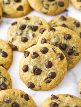 Closeup image of banana chocolate chip cookies scattered on a countertop.