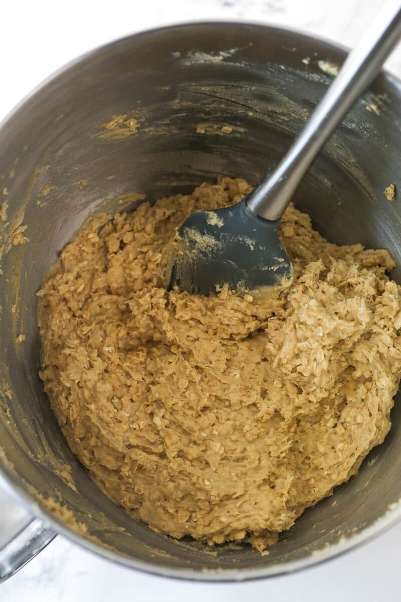Folding quick oats into cookie dough.