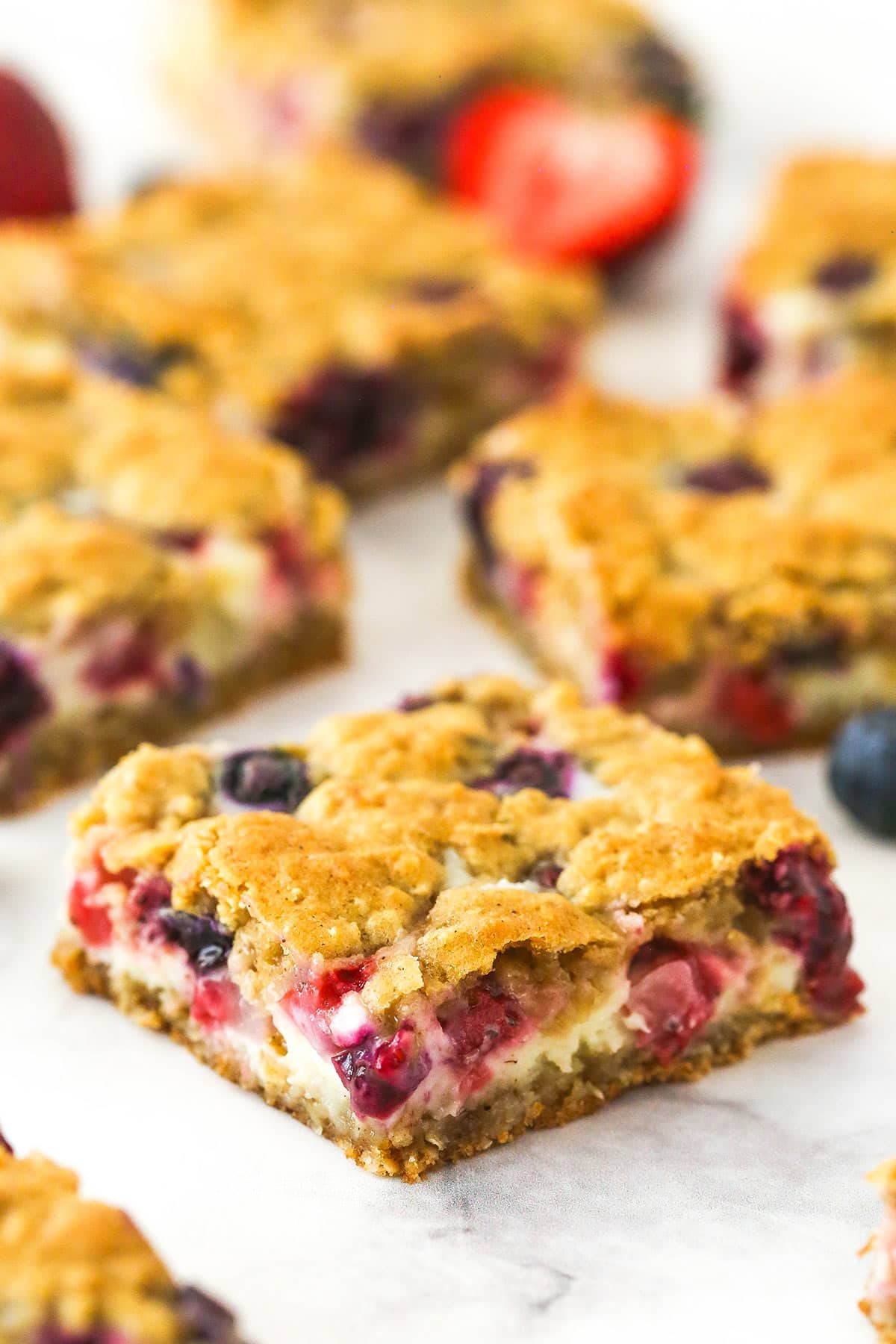 Berry oatmeal cheesecake bars on a countertop.