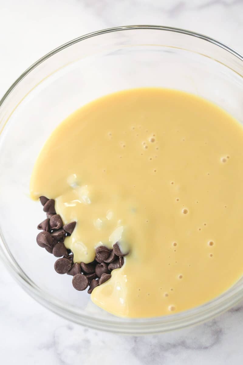 Combining sweetened condensed milk and chocolate chips.