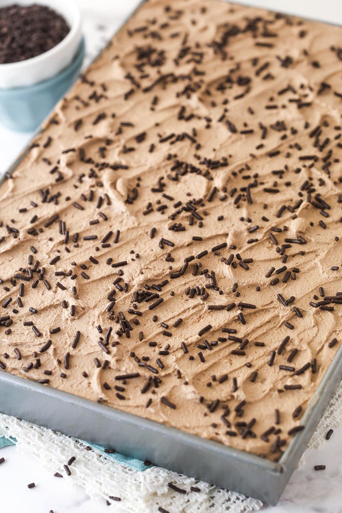 Overhead image of chocolate poke cake in a baking pan.
