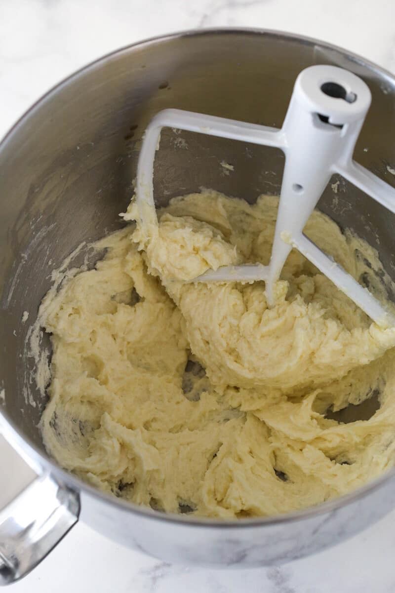 Mixing egg and vanilla into cookie cake dough.