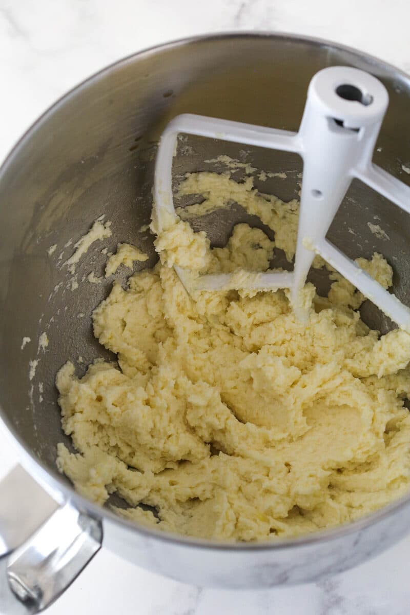 Mixing lemon juice and lemon zest into cookie cake dough.