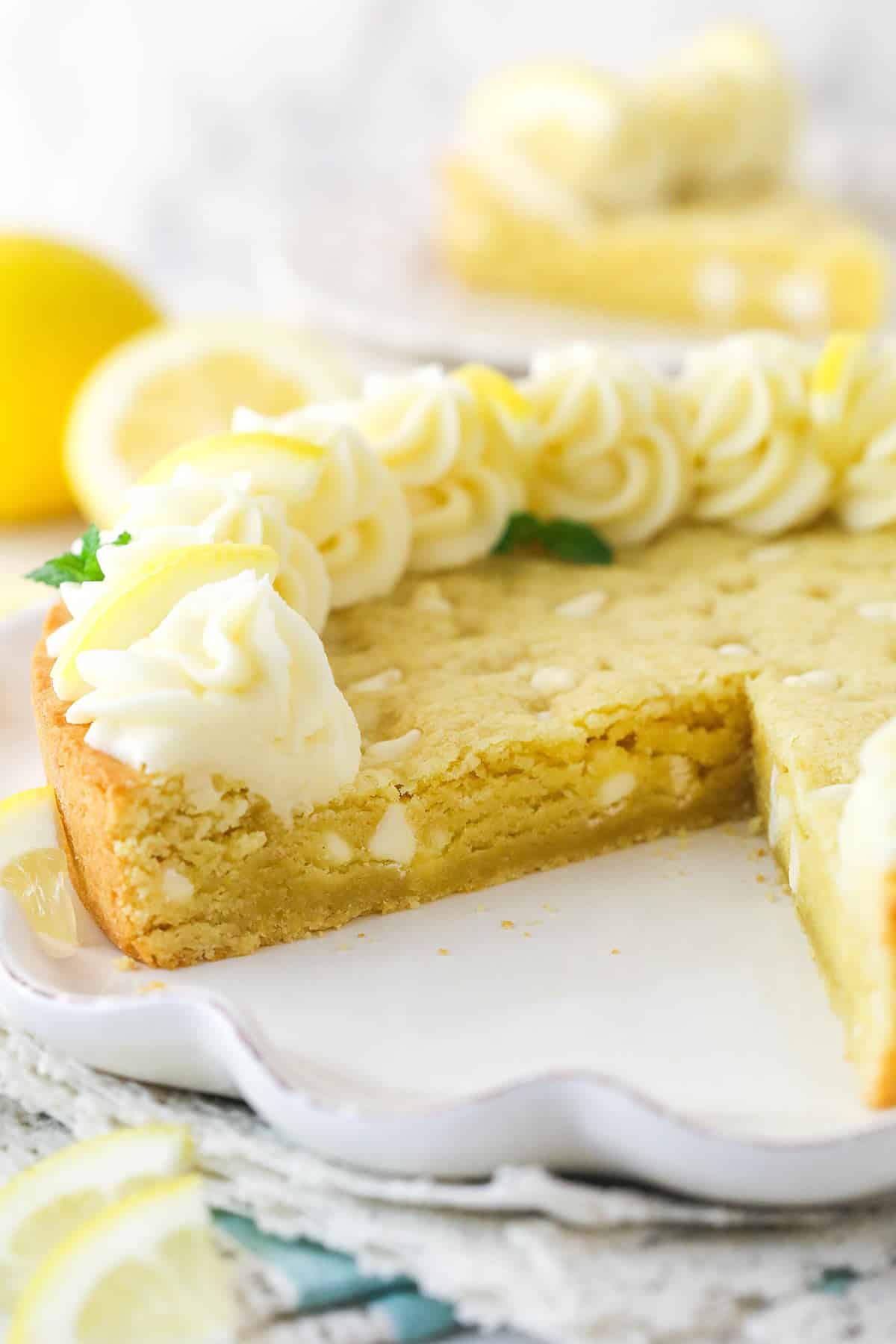 Lemon cookie cake with a slice taken out of it.
