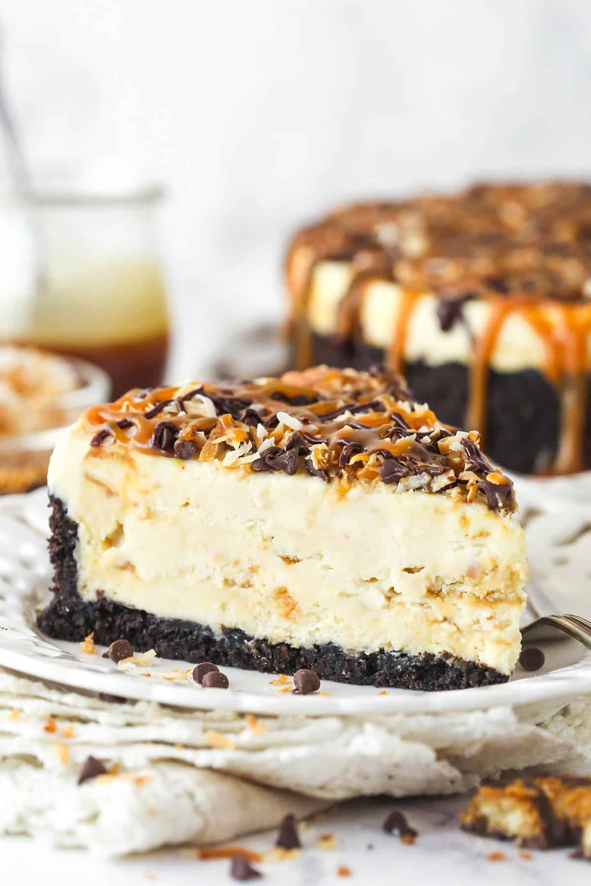 A slice of Samoa cheesecake on a plate.