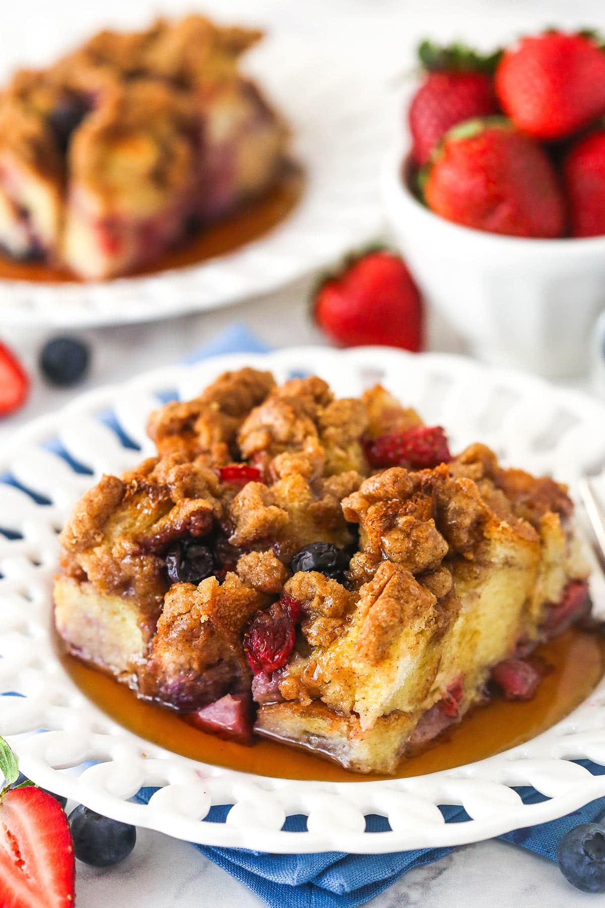 A slice of berry French toast casserole on a plate.