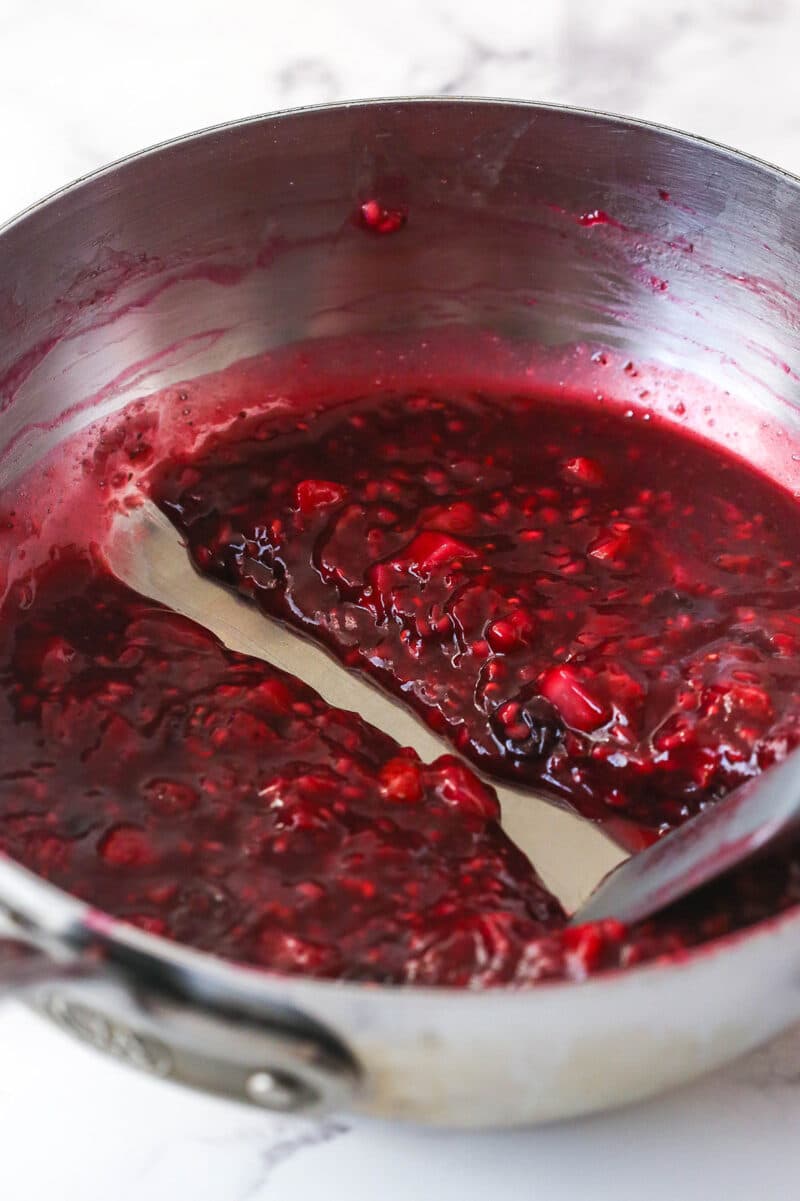 cooked berry filling in pan with a spatula run through it