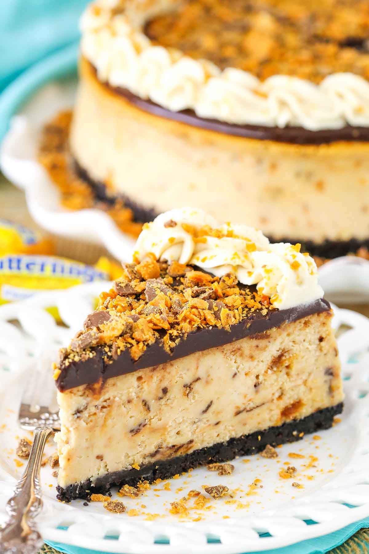 A slice of Butterfinger Cheesecake on a white plate