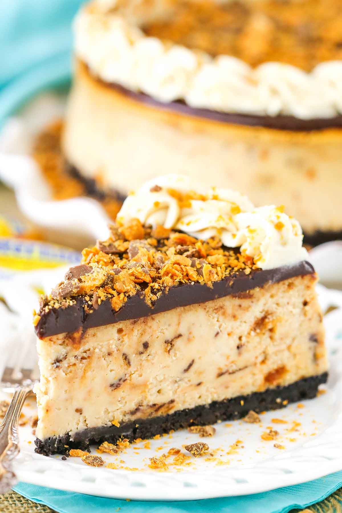 A slice of Butterfinger Cheesecake on a white plate