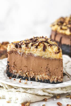 A slice of German chocolate cheesecake on a plate.