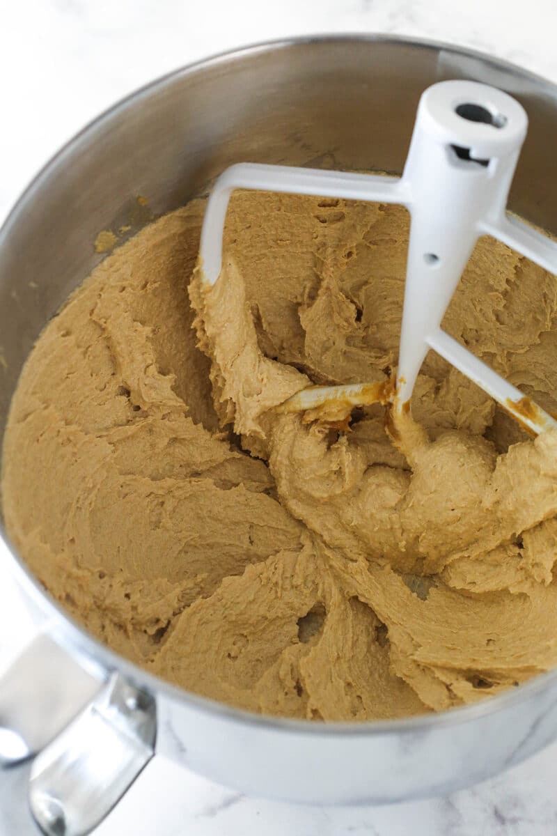 Creaming together butter, peanut butter, granulated sugar, and light brown sugar until light and fluffy.