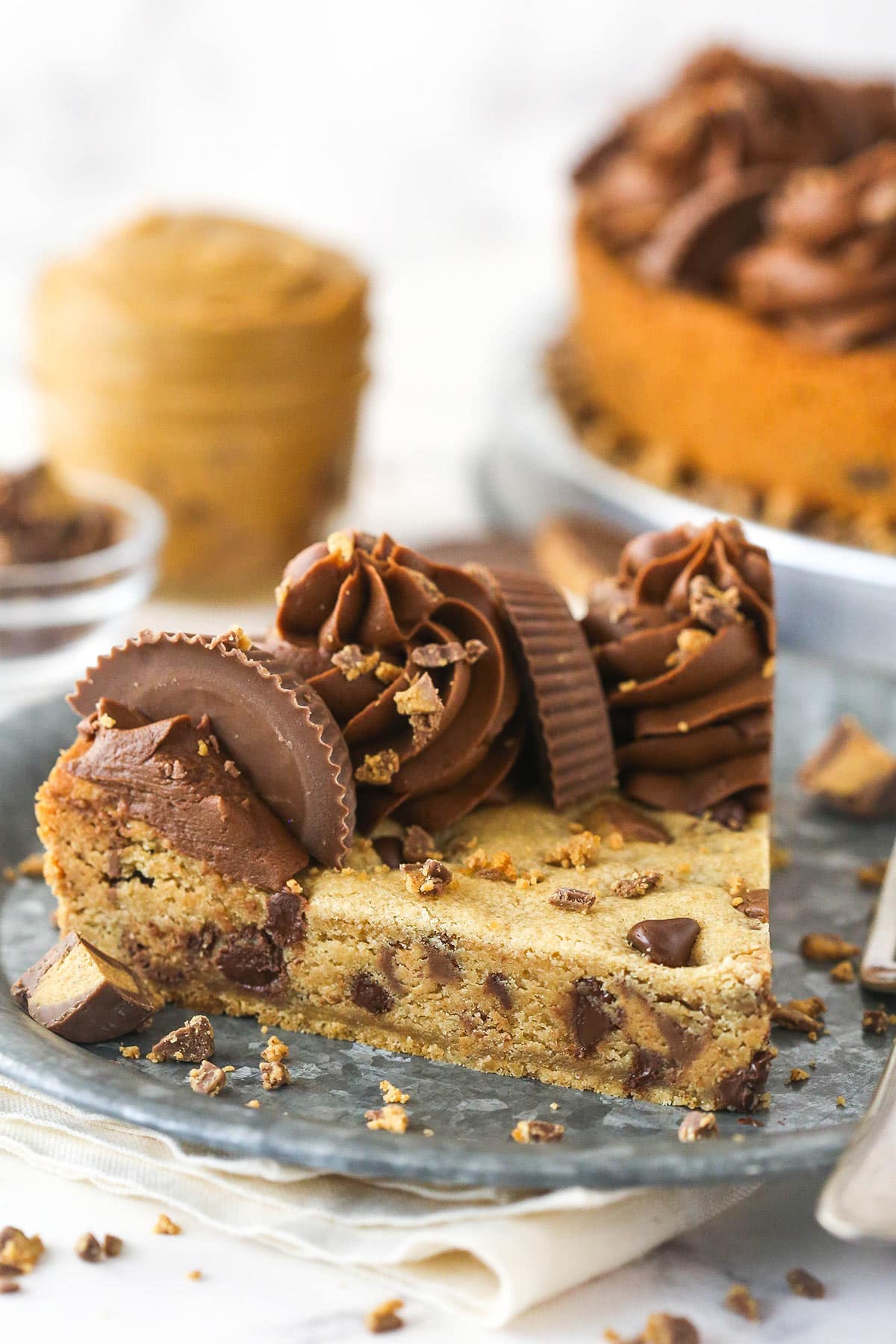 A slice of Reese's peanut butter cookie cake on a plate.