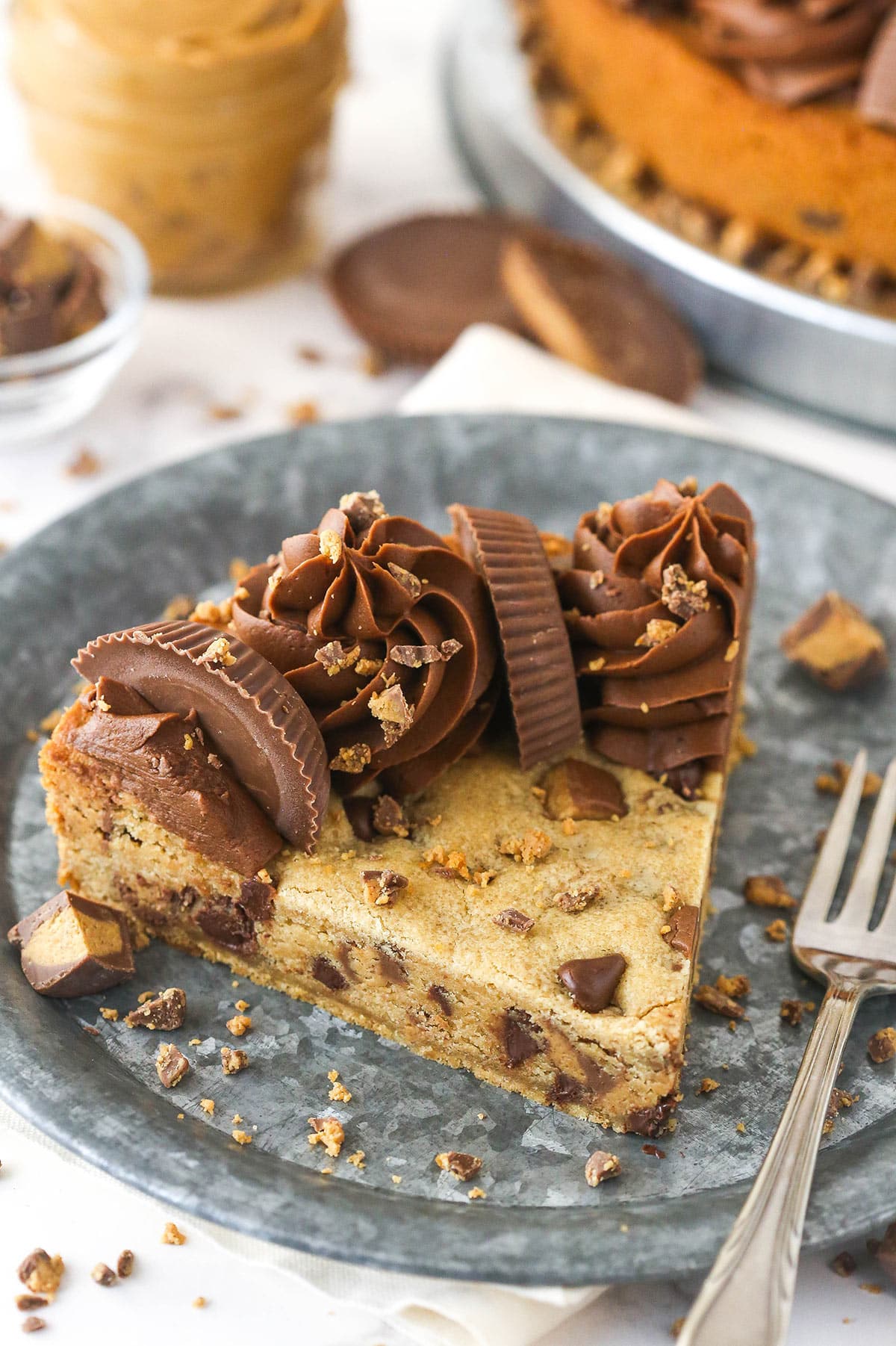 A slice of Reese's peanut butter cookie cake on a plate with a fork.