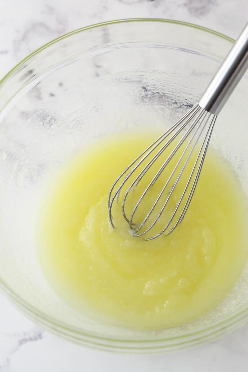 Whisking together the melted butter and sugar.