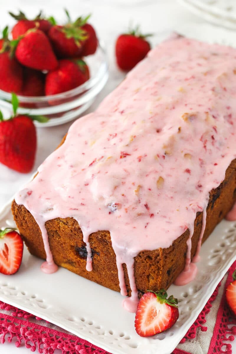 Glazed strawberry bread on a serving platter.