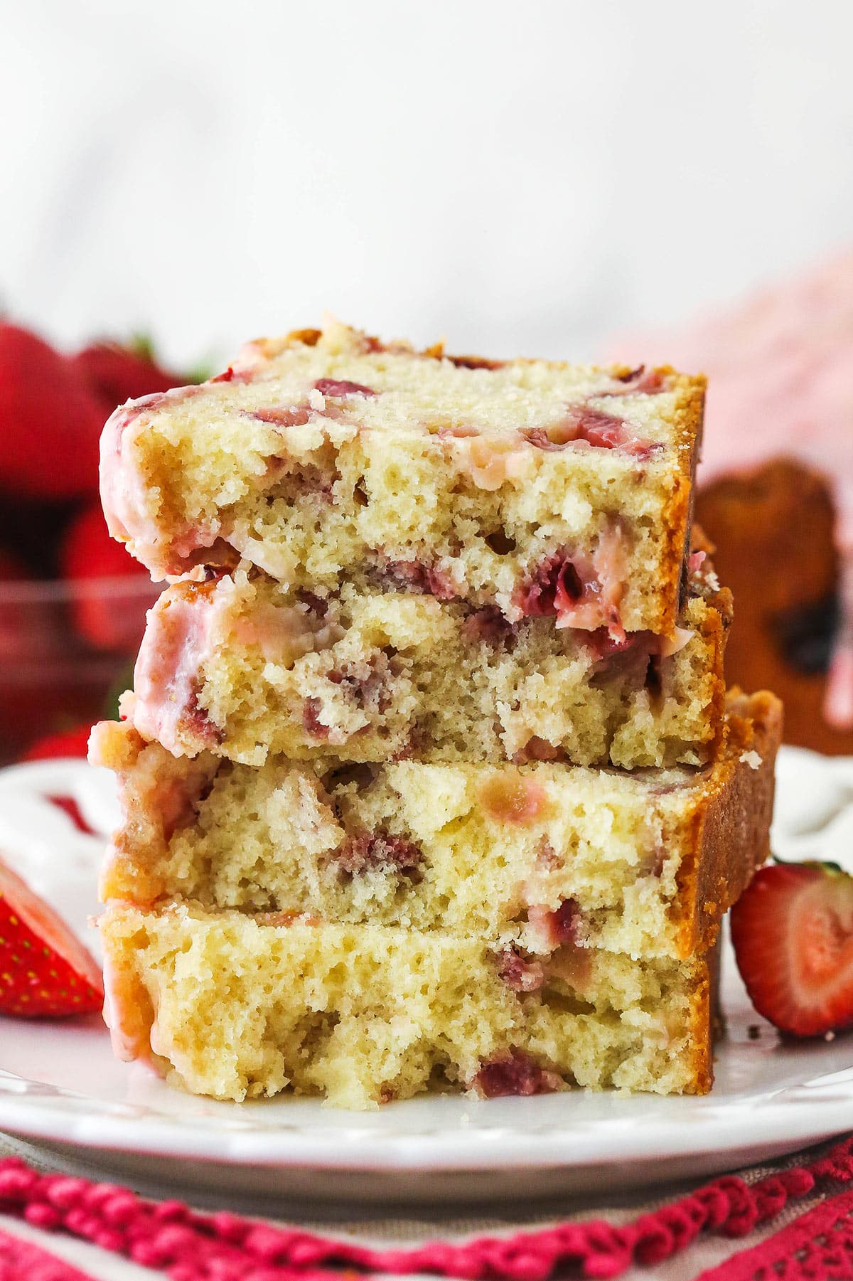 Slices of strawberry bread halved and stacked on top of one another.