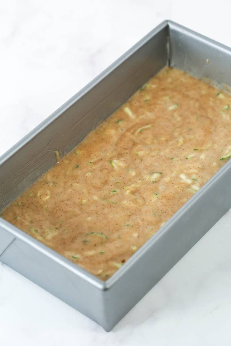 Zucchini bread batter in a loaf pan.