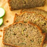 Overhead image of zucchini bread cut into slices on a cutting board.