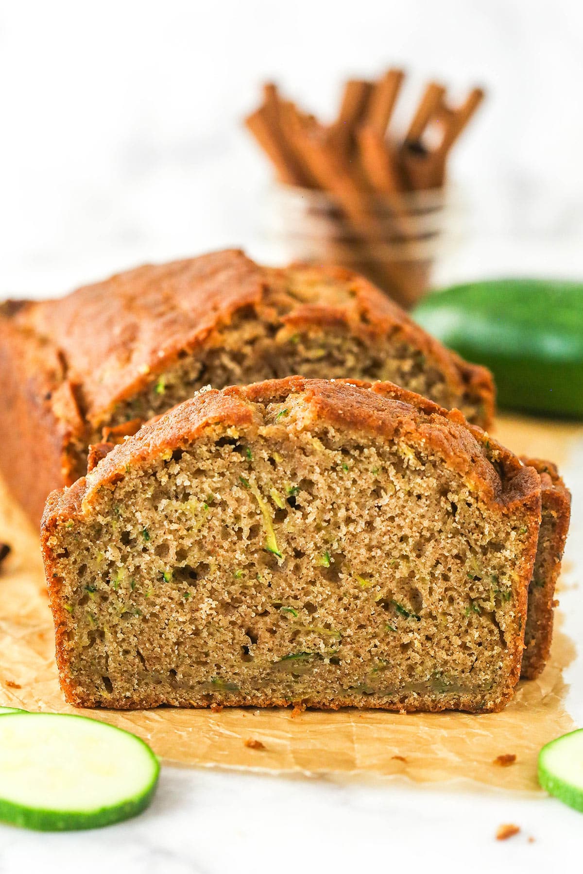 Zucchini bread cut into slices on a cutting board.