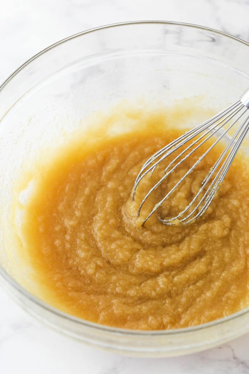 Whisking together the butter, vegetable oil, sugars, and vanilla.