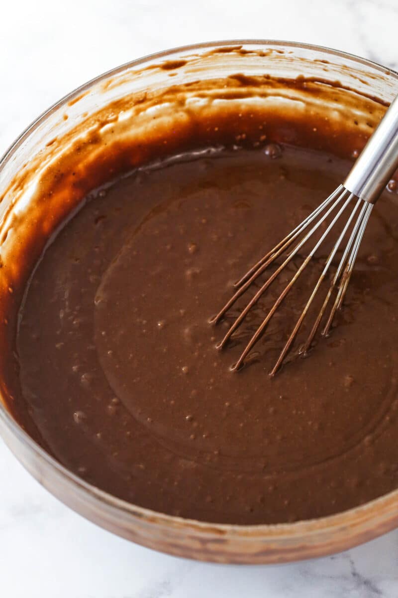 Mixing hot water into chocolate cake batter.