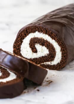 A homemade chocolate Swiss roll with two pieces sliced