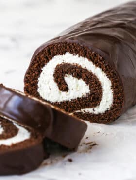 A homemade chocolate Swiss roll with two pieces sliced