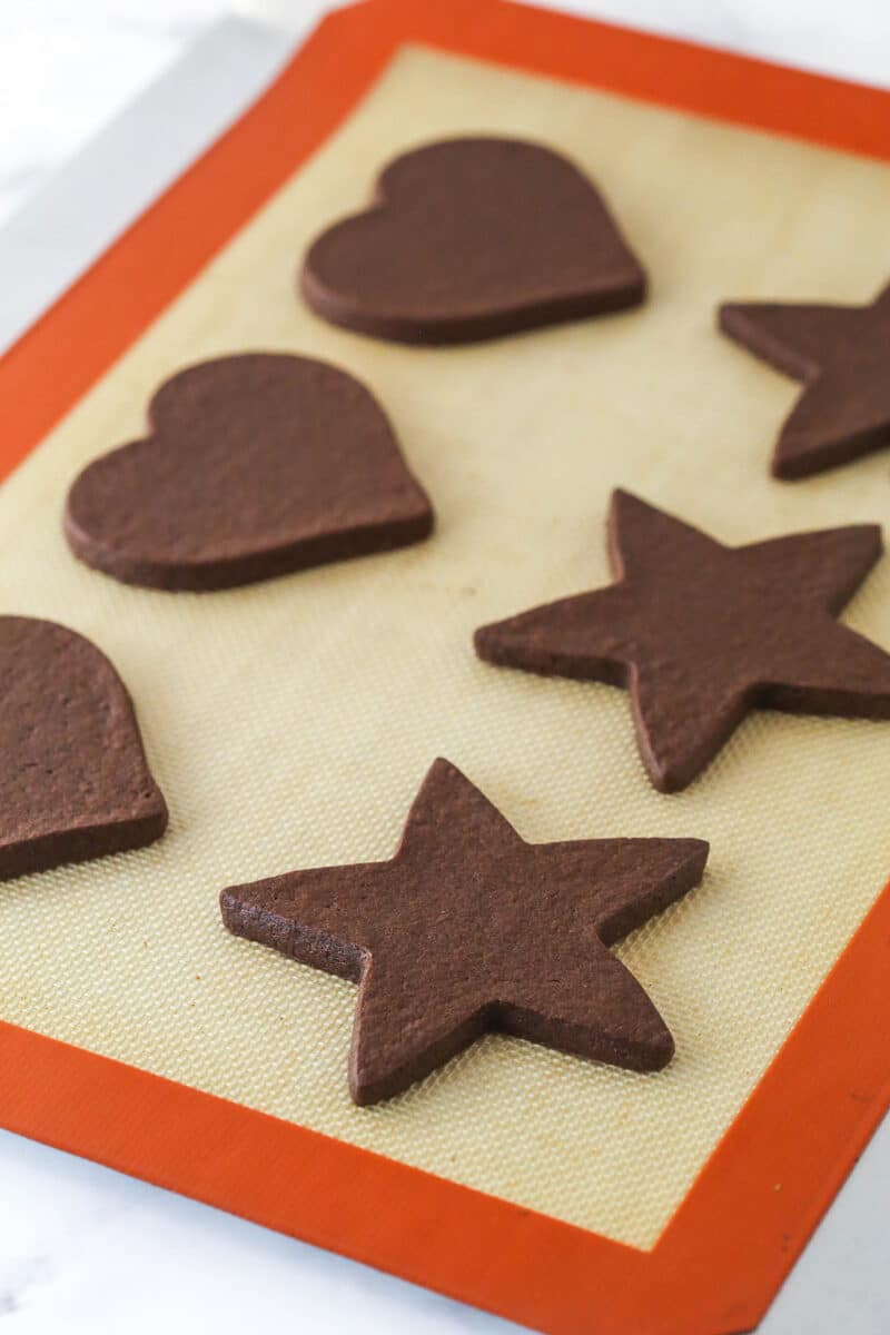 Baked cut out chocolate cookies on a baking sheet