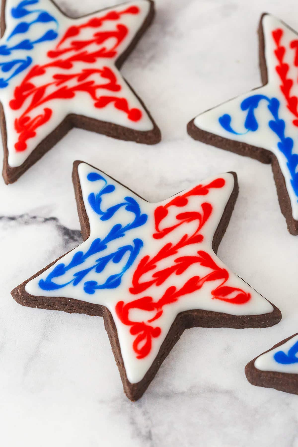 Chocolate cutout cookies decorated with red white and blue icing