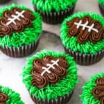 finished football cupcakes set on a marble background