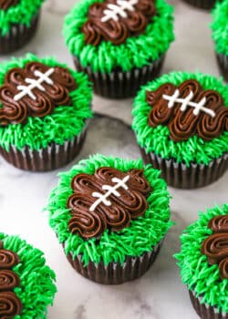 finished football cupcakes set on a marble background