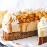 A Caramel Apple Blondie Cheesecake with a slice removed to show inner layers.