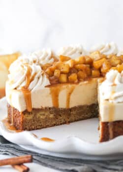 A Caramel Apple Blondie Cheesecake with a slice removed to show inner layers.