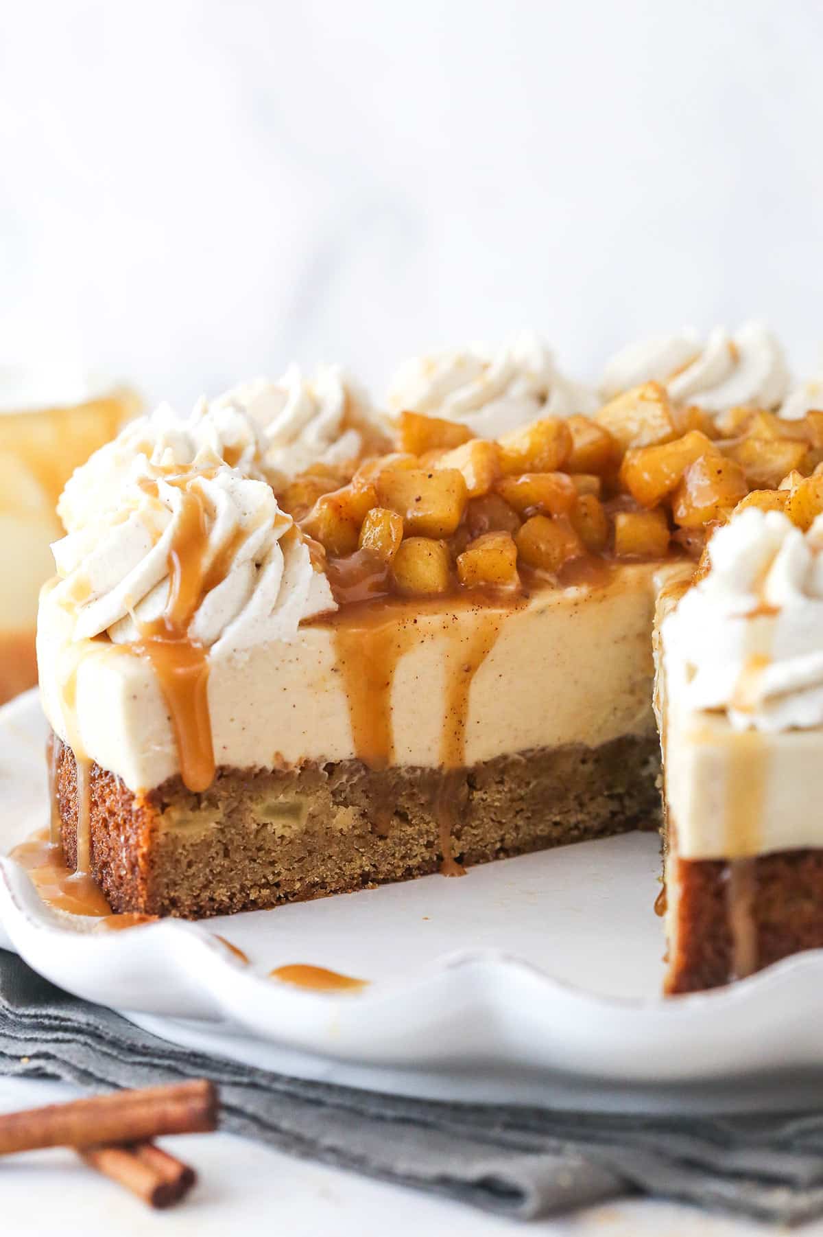 A Caramel Apple Blondie Cheesecake with a slice removed to show inner layers.