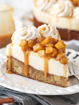 A slice of Caramel Apple Blondie Cheesecake on a small white plate.