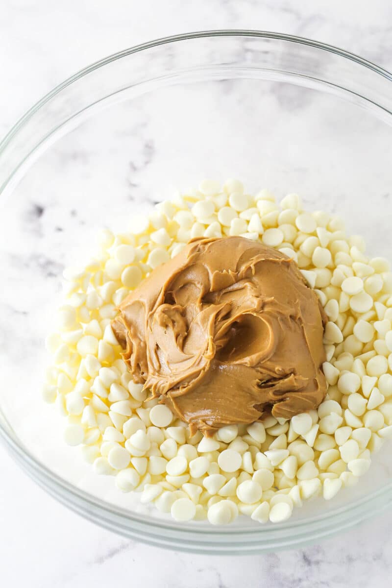 White chocolate chips and peanut butter in a glass bowl