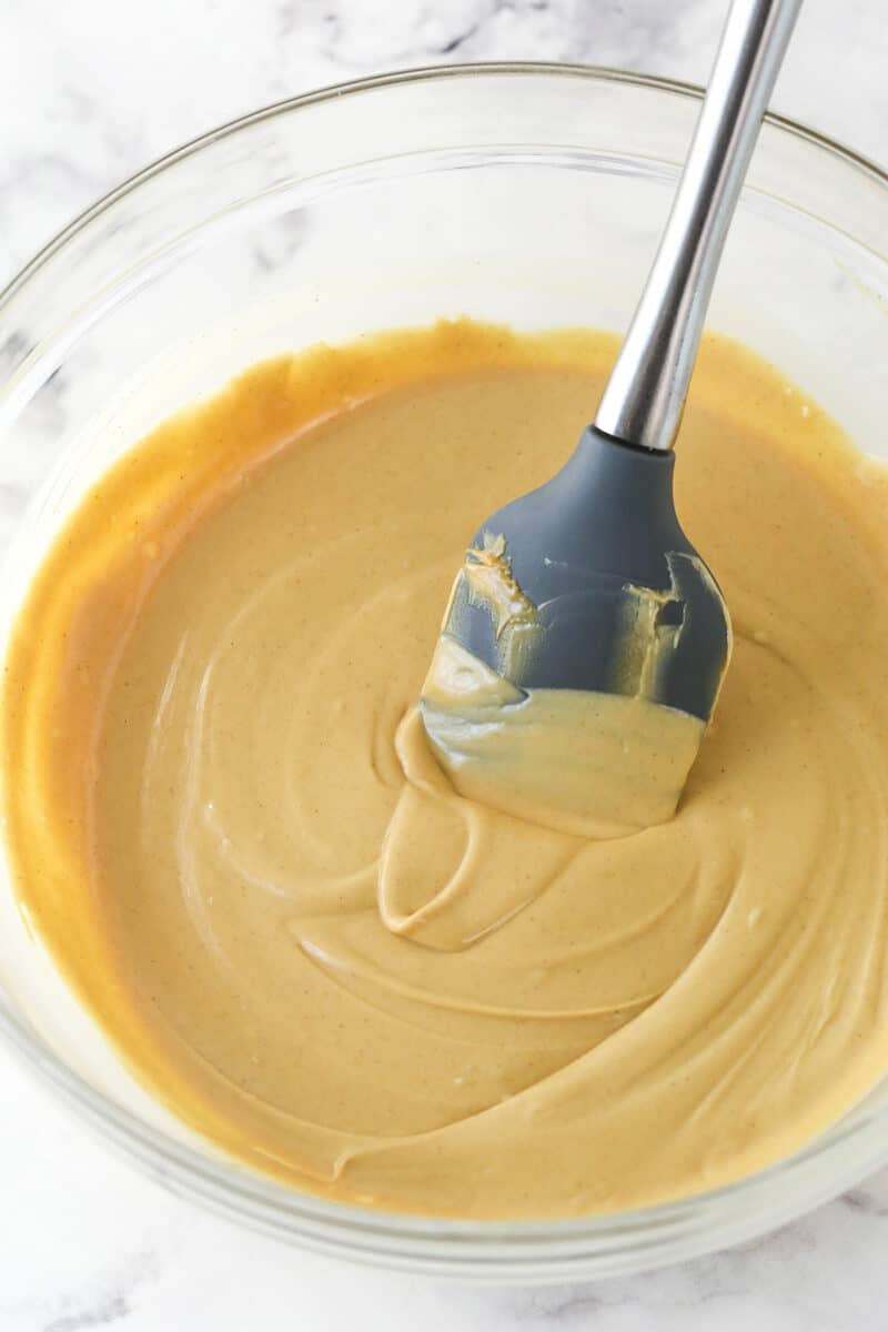 Stirring melted white chocolate and peanut butter together