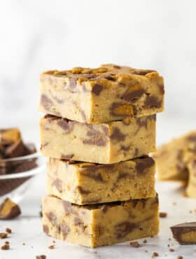 A stack of 4 pieces of Reese's peanut butter fudge