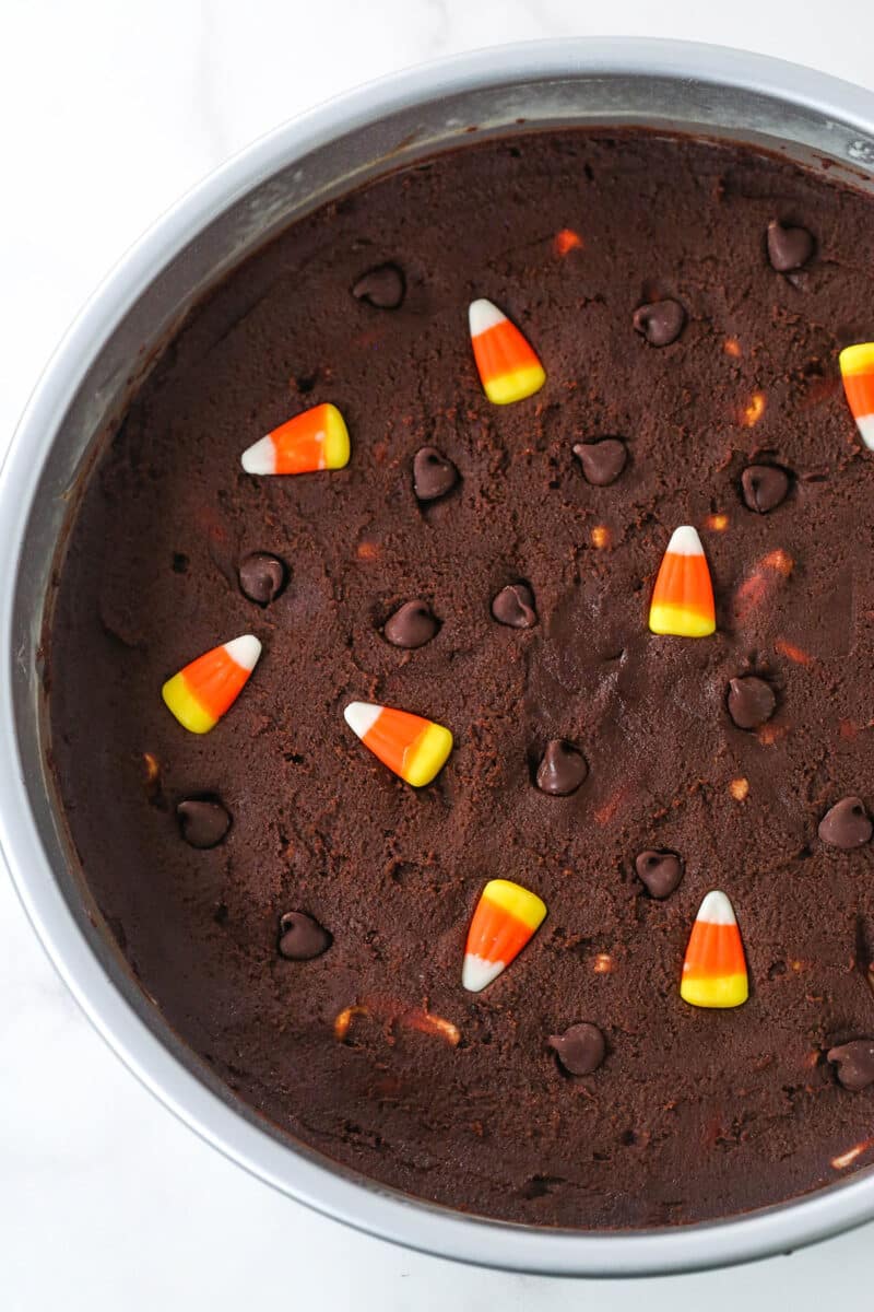 Candy Corn Chocolate Chip Cookie Cake batter spread into a baking pan.